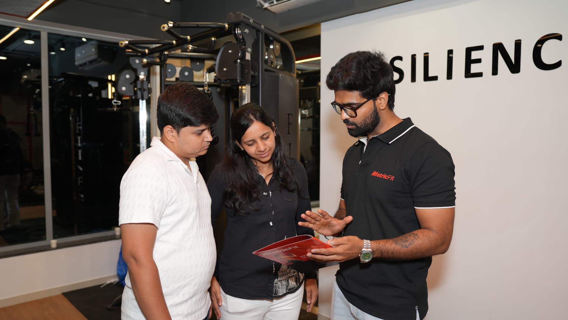 MetricFit coach walking a couple through their personalised plan
